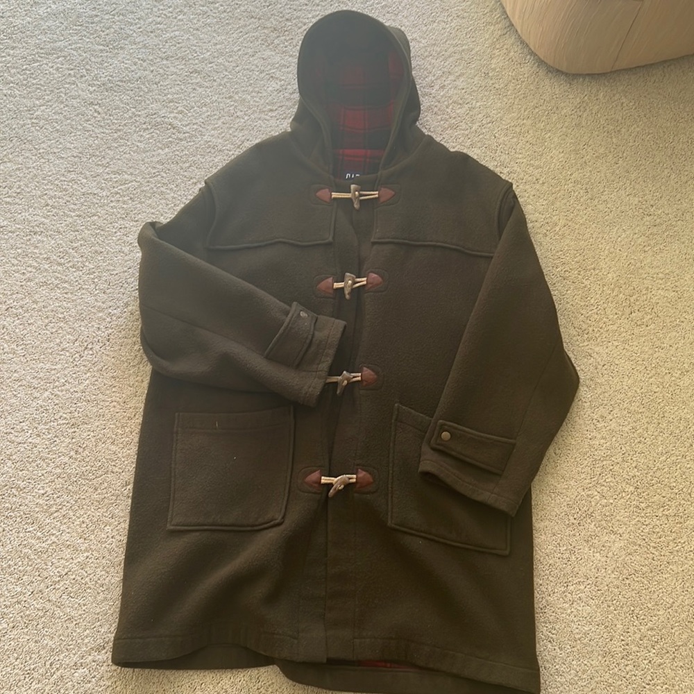 Green wool blend hooded coat. Houndstooth buttons. Red and black plaid interior.